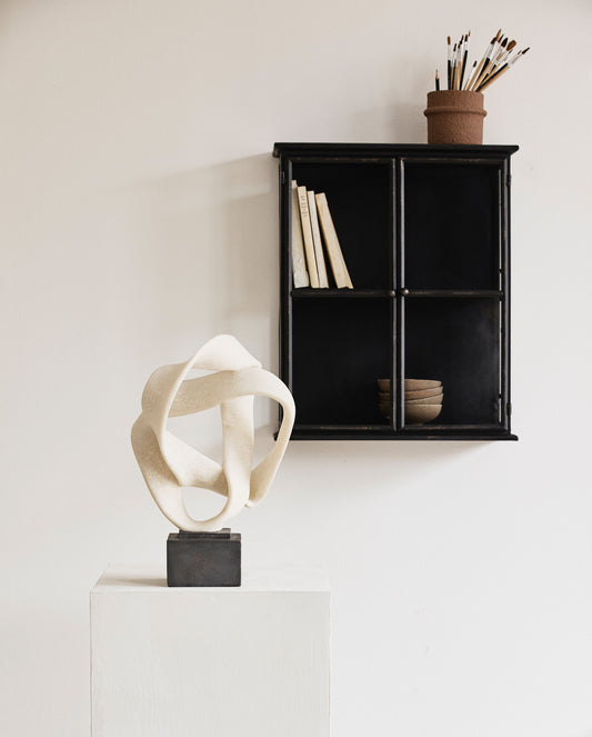 White sculpture on stand